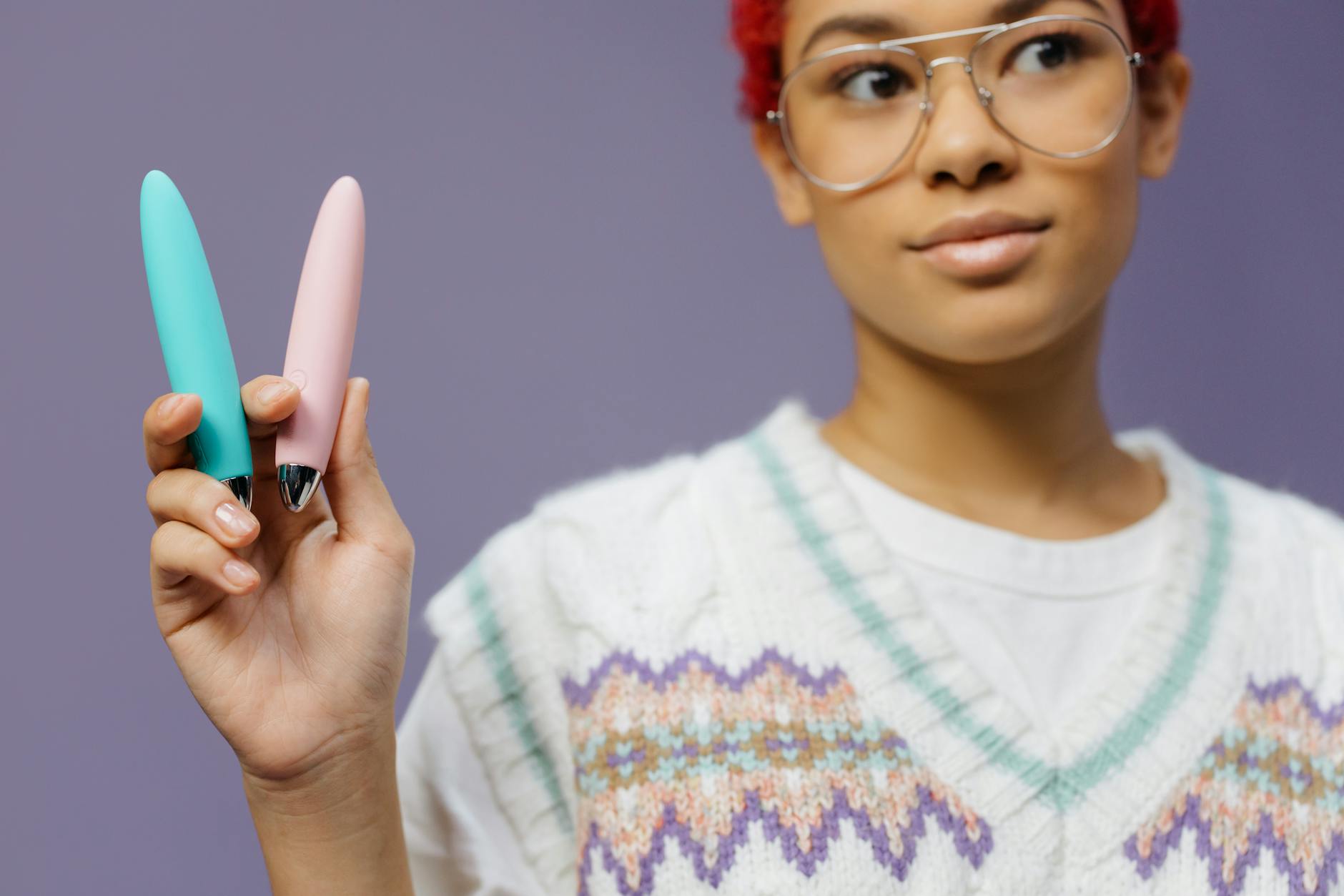 Colorful vibrators displayed against a purple background, representing pleasure tools for different needs